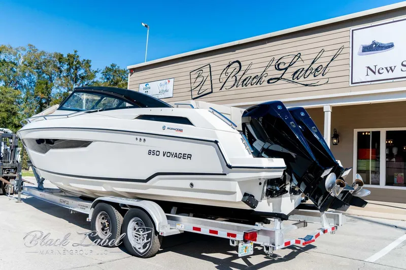 Ocean Phantom Yacht Photos Pics 2023 Hussar 850 Voyager boat on trailer outside Black Label store.