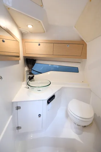 Ocean Phantom Yacht Photos Pics Modern bathroom interior in 2023 Hussar 850 boat, featuring sleek design and compact amenities.