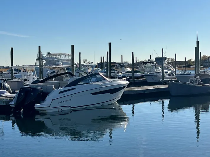 Ocean Phantom Yacht Photos Pics 2023 Hussar 850 boat docked in a marina under clear blue skies.