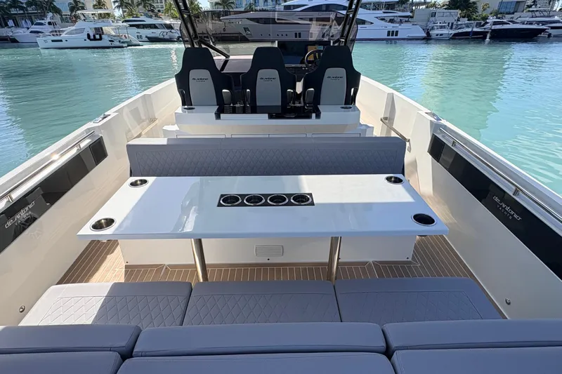 Casa - Ashanty Yacht Photos Pics 2025 De Antonio Yachts D32 interior with seating and table, docked in marina.