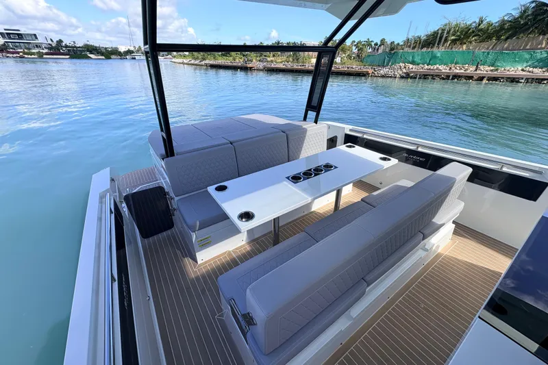 Casa - Ashanty Yacht Photos Pics 2025 De Antonio Yachts D32 interior with seating and table on calm water.