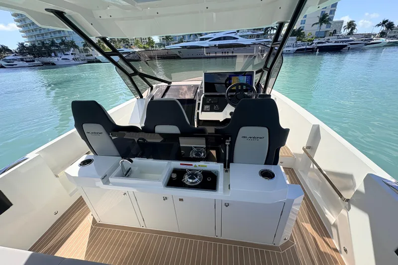 Casa - Ashanty Yacht Photos Pics 2025 De Antonio Yachts D32 cockpit with modern helm and seating, docked in marina.