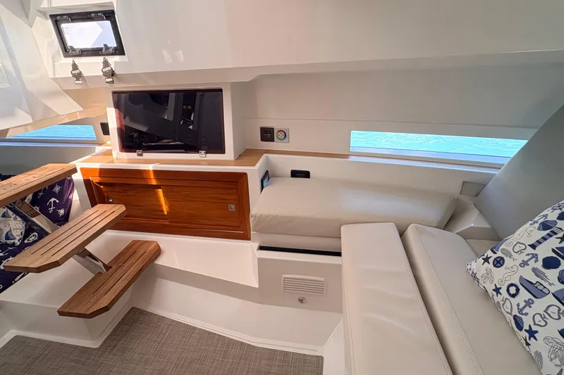 Casa - Ashanty Yacht Photos Pics Interior of 2025 De Antonio Yachts D32, featuring modern seating and wooden accents.