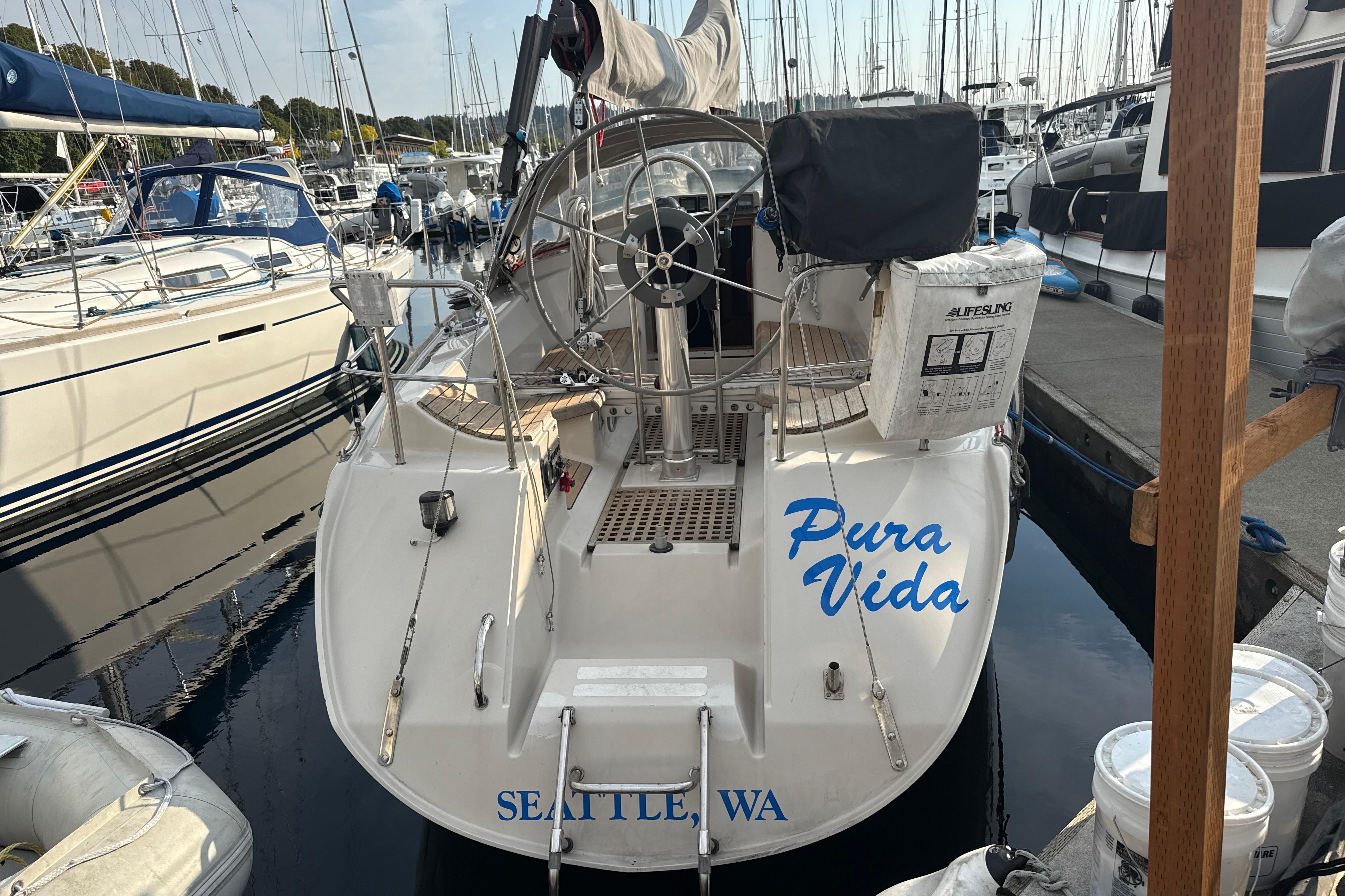 1985 Dehler 372 sailboat "Pura Vida" docked in Seattle marina.