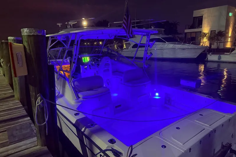  Yacht Photos Pics 2003 Grady-White Express 330 boat docked at night with blue interior lighting.