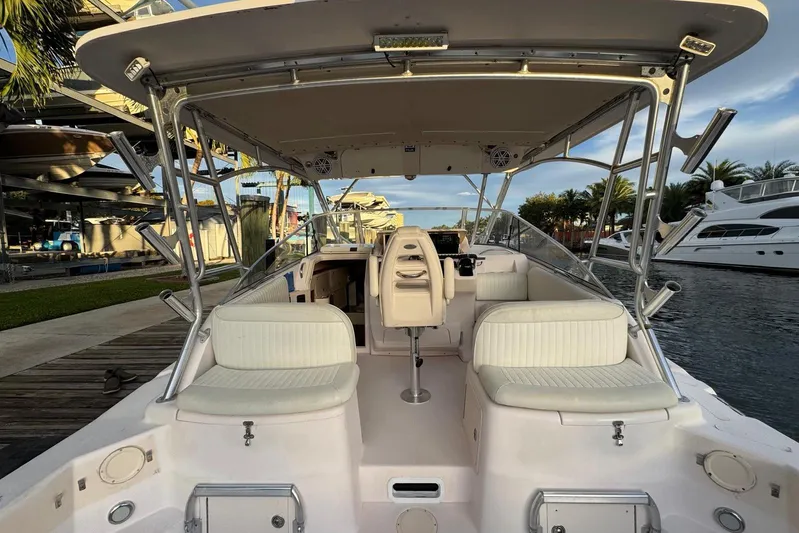  Yacht Photos Pics 2003 Grady-White Express 330 boat interior with seating and helm, docked by the water.