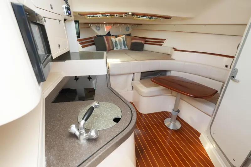  Yacht Photos Pics 2003 Grady-White Express 330 cabin interior with kitchenette and seating area.