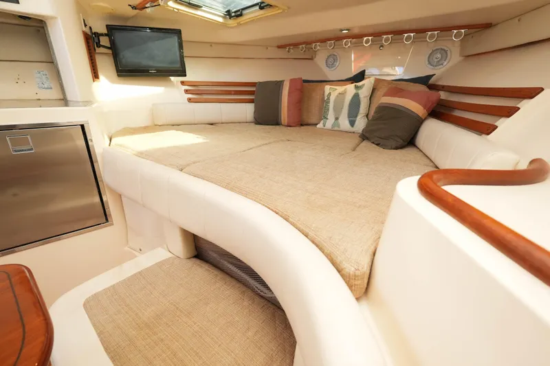  Yacht Photos Pics Luxurious interior of 2003 Grady-White Express 330 boat with cozy seating and TV.