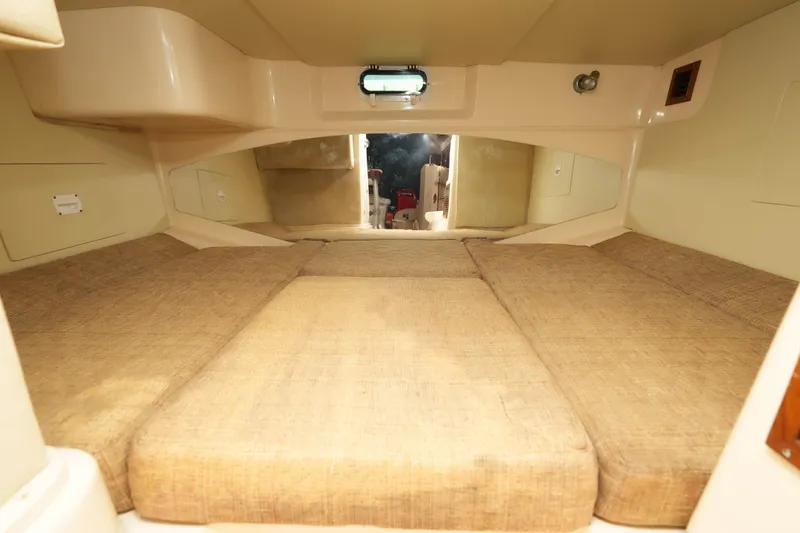  Yacht Photos Pics 2003 Grady-White Express 330 cabin interior with beige cushions and compact design.