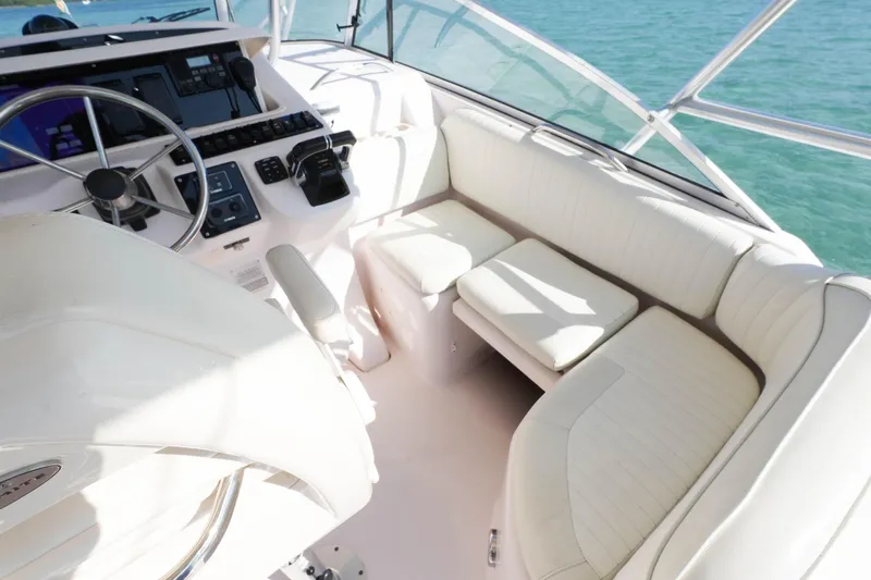  Yacht Photos Pics 2003 Grady-White Express 330 boat interior with steering wheel and seating area.