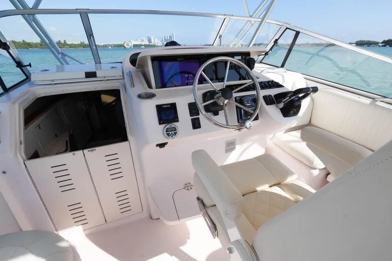  Yacht Photos Pics 2003 Grady-White Express 330 helm with steering wheel and navigation equipment.
