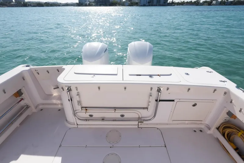  Yacht Photos Pics 2003 Grady-White Express 330 boat deck with twin engines on calm water.