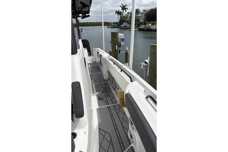  Yacht Photos Pics 2024 Fountain 32 NX Sportfish boat docked, showcasing sleek deck design and waterfront view.