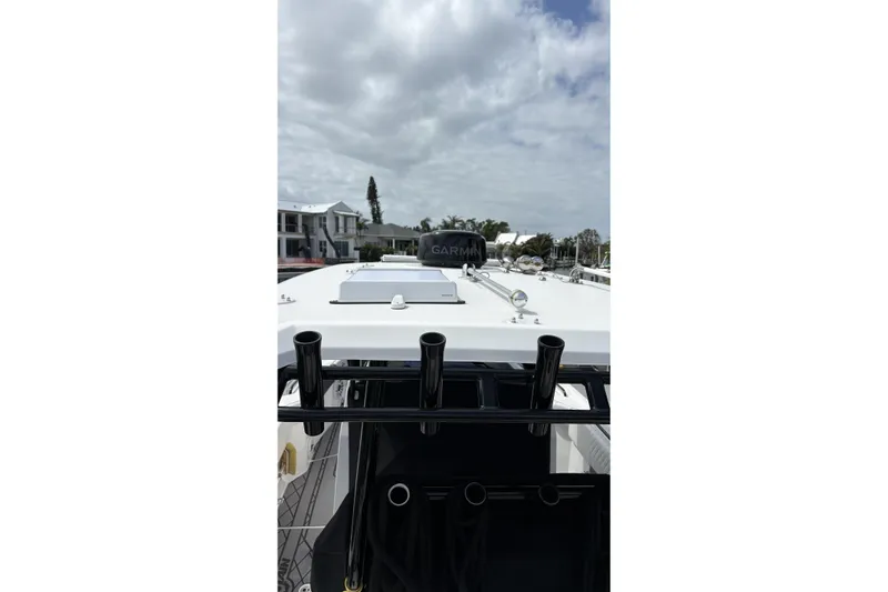  Yacht Photos Pics 2024 Fountain 32 NX Sportfish boat with Garmin equipment, docked under cloudy skies.