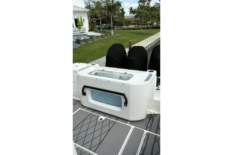  Yacht Photos Pics 2024 Fountain 32 NX Sportfish boat deck with livewell and covered engines.