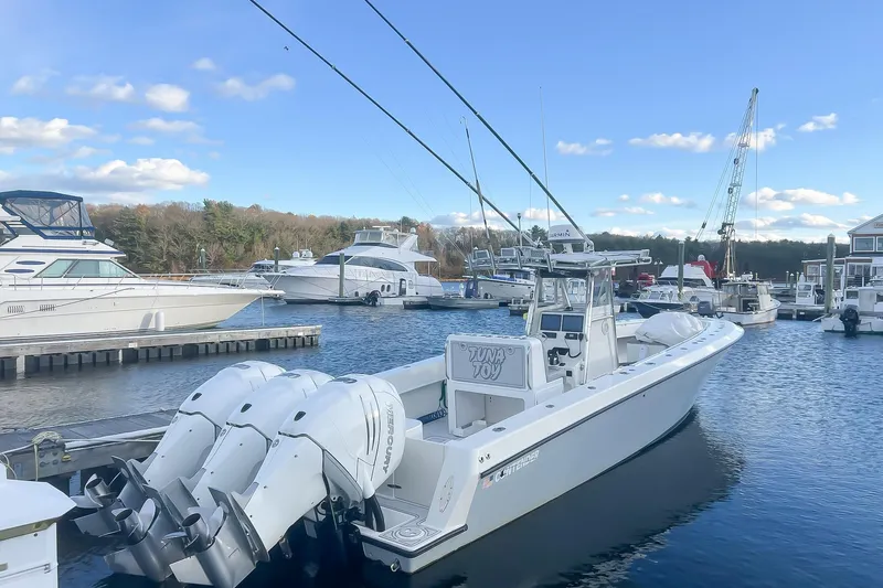 Tuna Toy Yacht Photos Pics 2002 Contender 36 Open boat docked in a marina with clear blue skies.
