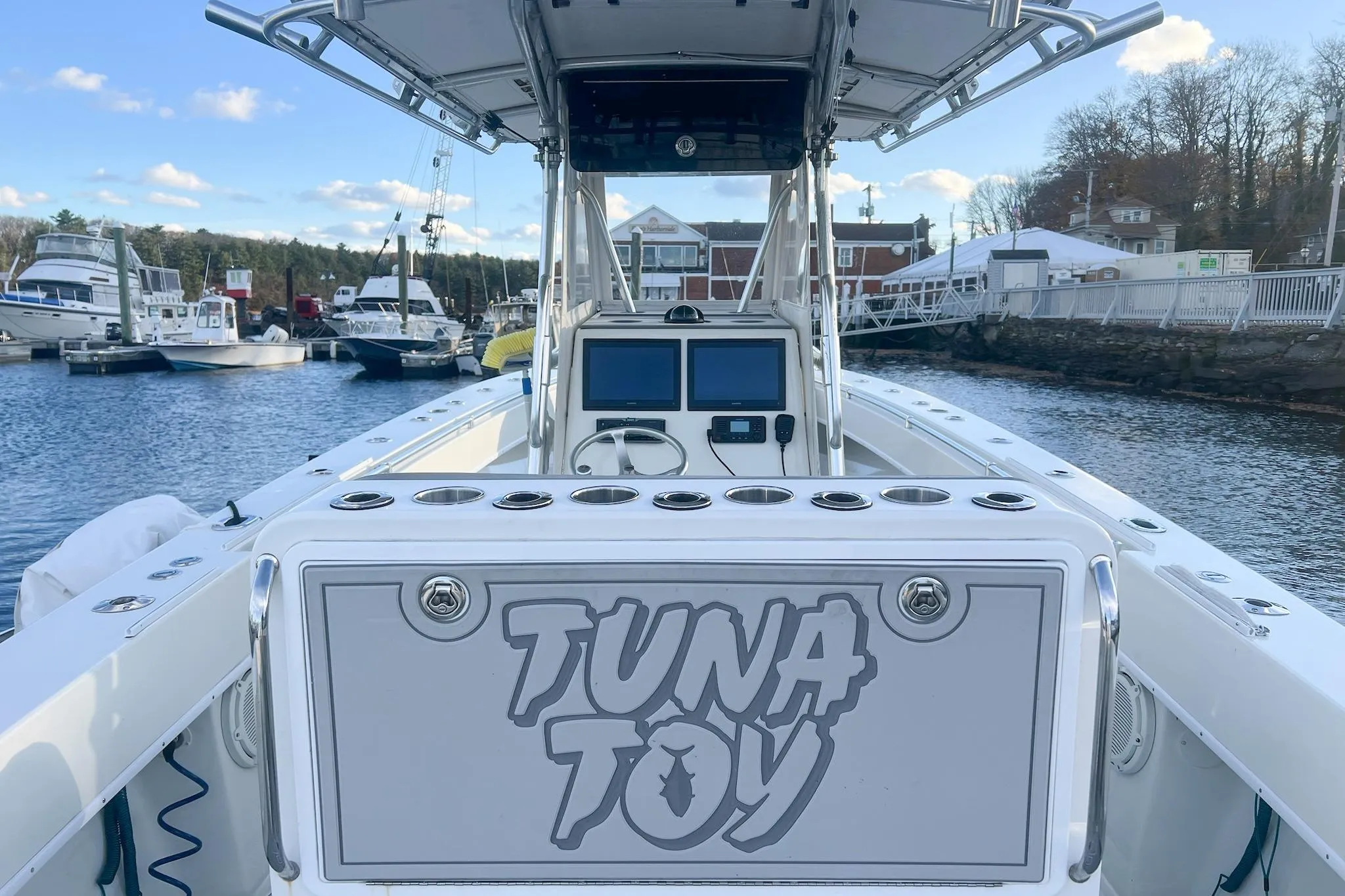 2002 Contender 36 Open boat named "Tuna Toy" docked at a marina.
