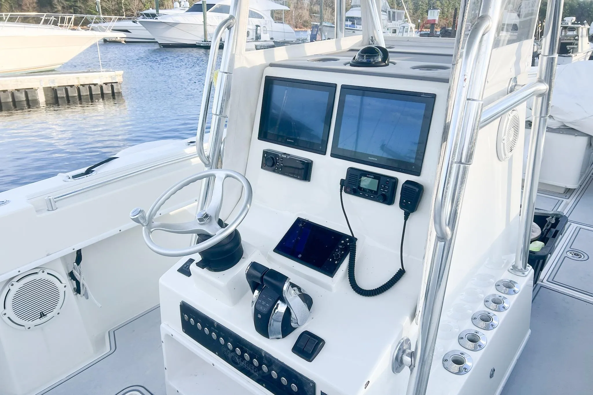 2002 Contender 36 Open boat console with navigation screens and controls at marina.