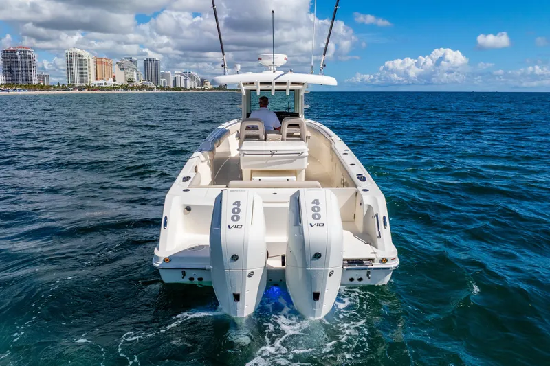 Bwce0715h122 Yacht Photos Pics 2022 Boston Whaler 330 Outrage cruising on ocean near city skyline.