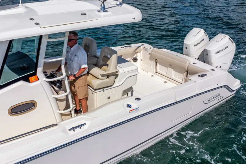 Bwce0715h122 Yacht Photos Pics 2022 Boston Whaler 330 Outrage boat on water, featuring dual Mercury engines.