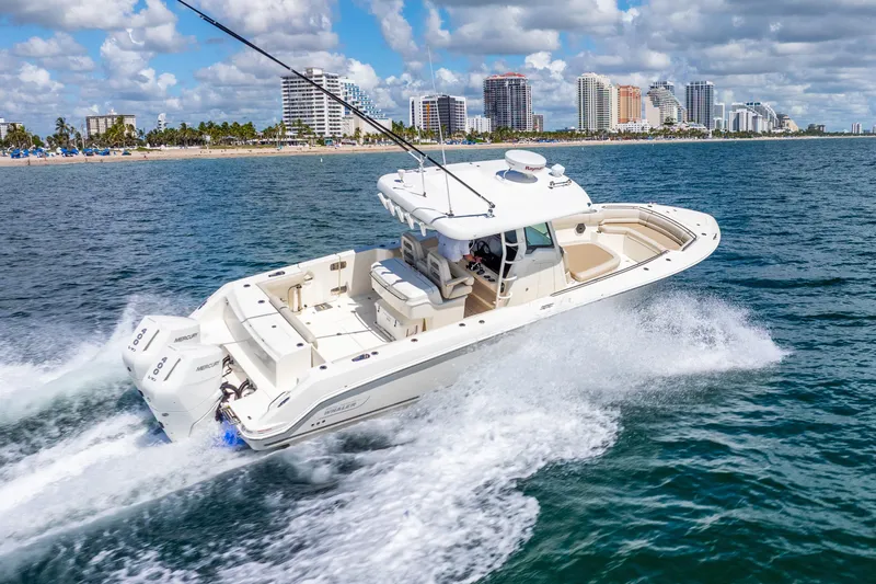 Bwce0715h122 Yacht Photos Pics 2022 Boston Whaler 330 Outrage cruising on ocean near city skyline.