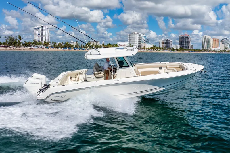 Bwce0715h122 Yacht Photos Pics 2022 Boston Whaler 330 Outrage cruising on ocean near city skyline.