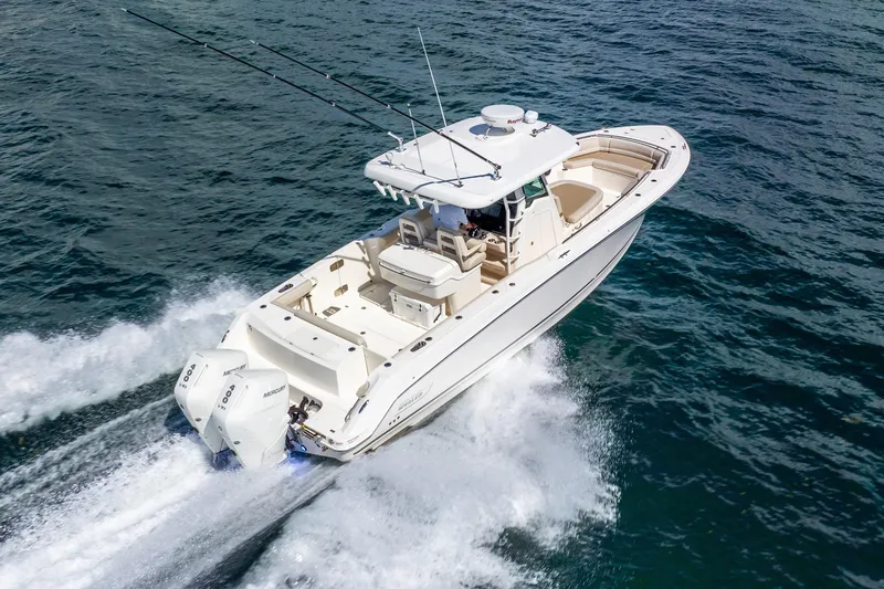 Bwce0715h122 Yacht Photos Pics 2022 Boston Whaler 330 Outrage cruising on open water, showcasing powerful twin engines.