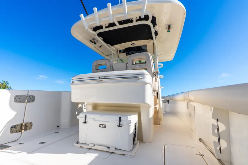 Bwce0715h122 Yacht Photos Pics 2022 Boston Whaler 330 Outrage boat interior with Yeti cooler, blue sky background.
