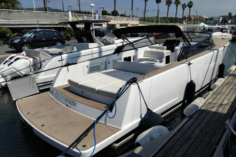  Yacht Photos Pics 2024 VanDutch 40 yacht docked at marina, showcasing sleek design and spacious deck.