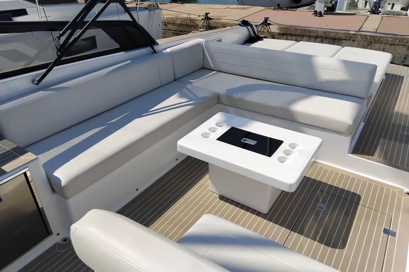  Yacht Photos Pics Luxurious seating area on 2024 VanDutch 40 yacht with modern table and sleek design.