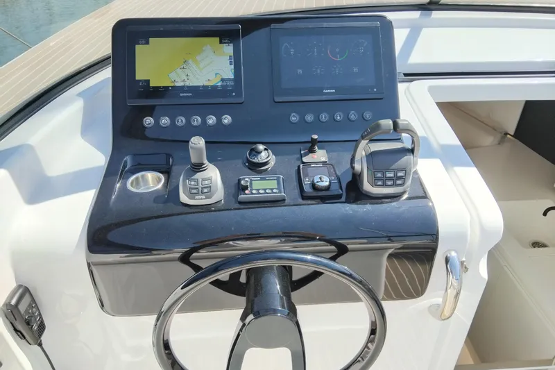  Yacht Photos Pics Control panel of 2024 VanDutch 40 yacht with navigation screens and steering wheel.