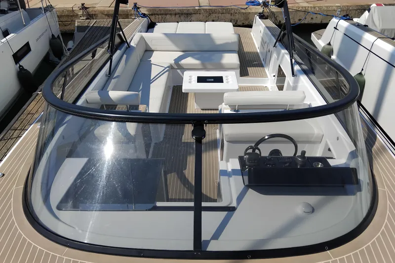  Yacht Photos Pics 2024 VanDutch 40 yacht with sleek design, spacious seating, and modern helm in a marina setting.