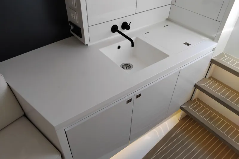  Yacht Photos Pics Modern kitchen area in 2024 VanDutch 40 yacht with sleek white cabinetry and sink.