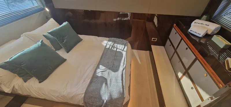 In Stock Yacht Photos Pics Luxurious bedroom interior of 2025 Fairline Targa 45 Open yacht with elegant bedding.