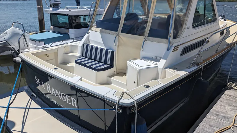 Sea Ranger Yacht Photos Pics 2008 Sabre 34 Express boat docked, featuring a spacious deck and striped seating.