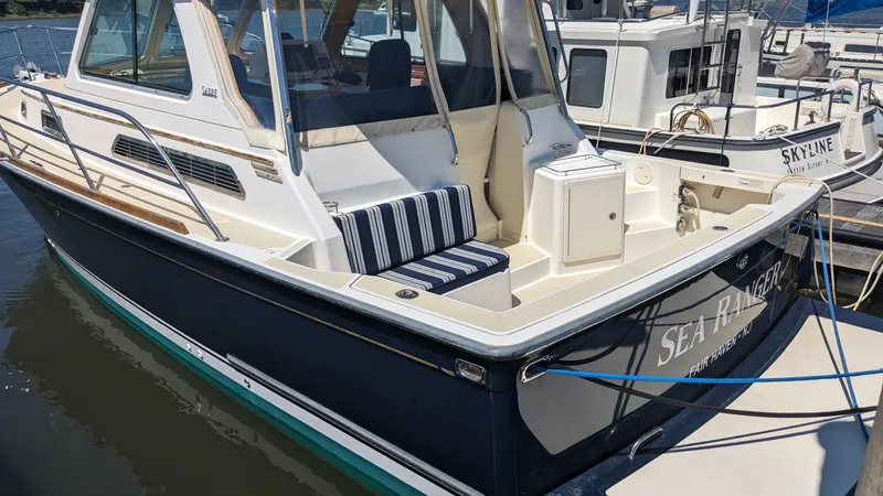 Sea Ranger Yacht Photos Pics 2008 Sabre 34 Express boat docked with striped seating and name Sea Razer.