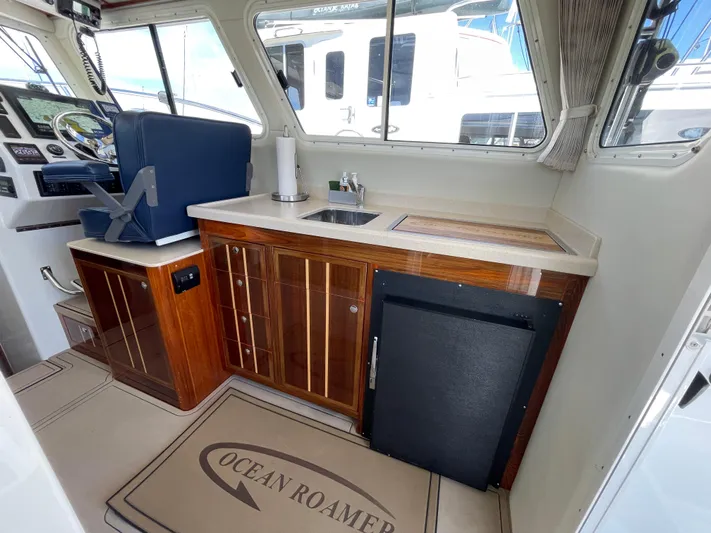 Ocean Roamer Yacht Photos Pics Interior of 2016 Lindell Ocean Roamer boat with helm and kitchenette area.