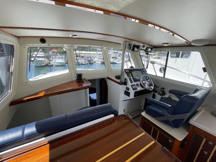 Ocean Roamer Yacht Photos Pics Interior of 2016 Lindell Ocean Roamer boat with helm, seating, and marina view.