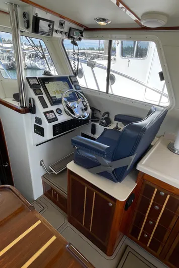 Ocean Roamer Yacht Photos Pics 2016 Lindell Ocean Roamer helm with navigation equipment and blue captain's chair.