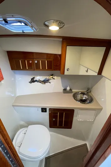 Ocean Roamer Yacht Photos Pics 2016 Lindell Ocean Roamer bathroom with sink, toilet, and wooden cabinetry.