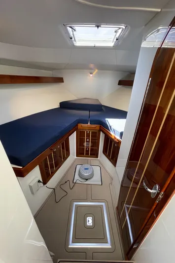 Ocean Roamer Yacht Photos Pics Interior of 2016 Lindell Ocean Roamer boat with wooden cabinets and blue cushions.