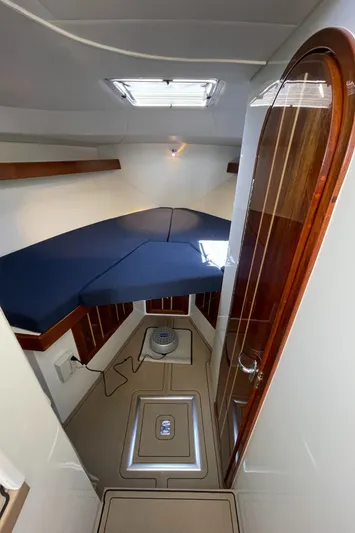 Ocean Roamer Yacht Photos Pics 2016 Lindell Ocean Roamer cabin interior with blue cushions and wooden accents.