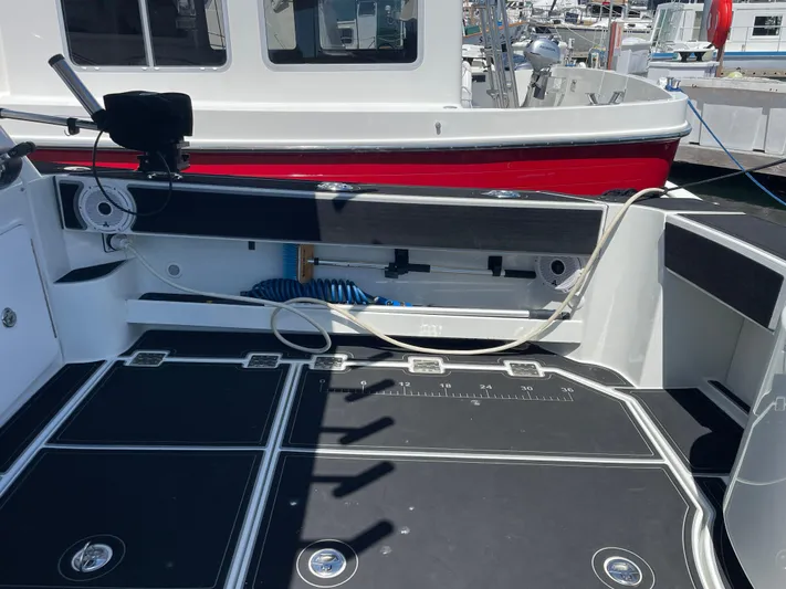 Ocean Roamer Yacht Photos Pics 2016 Lindell Ocean Roamer boat deck with fishing equipment and storage compartments.