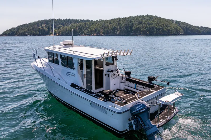 Ocean Roamer Yacht Photos Pics 2016 Lindell Ocean Roamer boat cruising on scenic blue waters near a forested island.