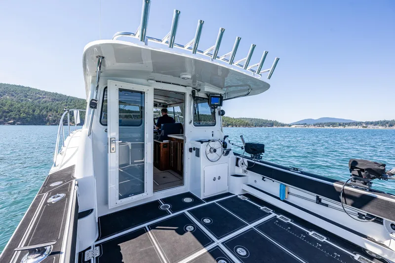 Ocean Roamer Yacht Photos Pics 2016 Lindell Ocean Roamer boat on scenic water with clear sky and lush landscape.