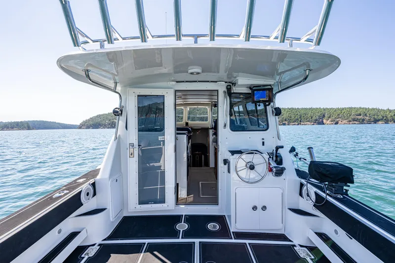 Ocean Roamer Yacht Photos Pics 2016 Lindell Ocean Roamer boat interior with steering wheel, open sea view, and clear skies.