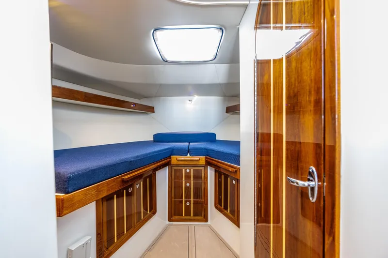 Ocean Roamer Yacht Photos Pics 2016 Lindell Ocean Roamer cabin interior with wooden finishes and blue cushions.