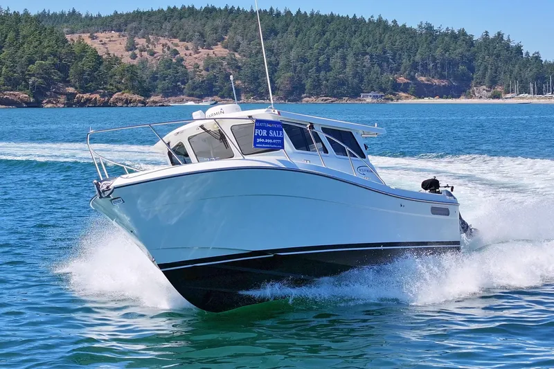 Ocean Roamer Yacht Photos Pics 2016 Lindell Ocean Roamer boat cruising on blue water, forested shoreline in background.