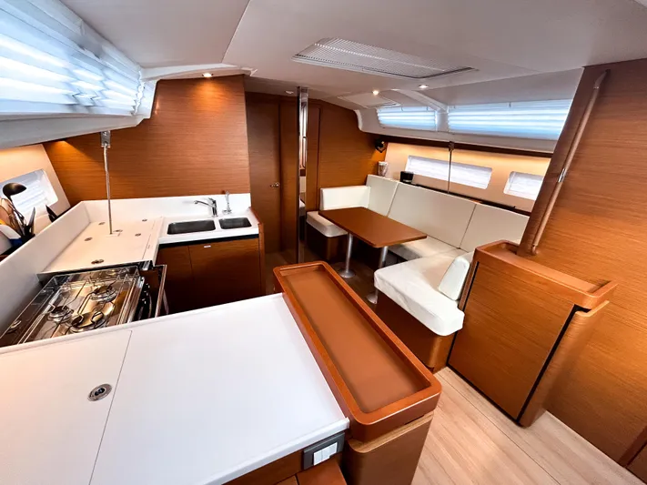 Rhythm & Blues Yacht Photos Pics 2024 Jeanneau Sun Odyssey 440 interior with modern kitchen and cozy seating area.