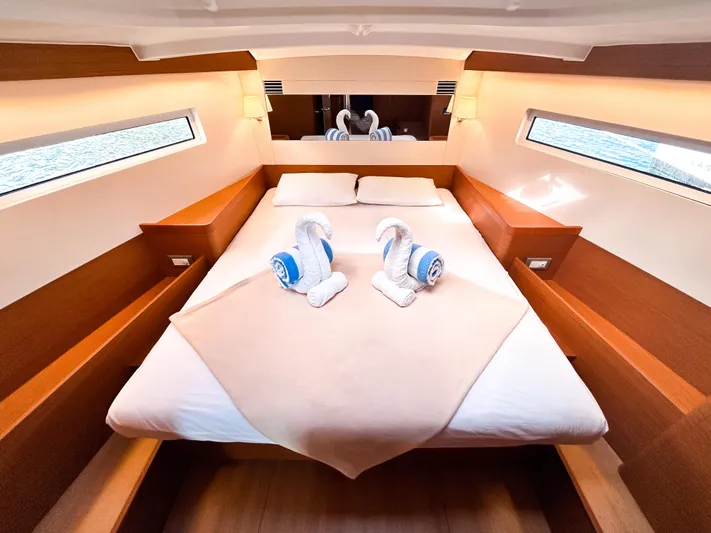 Rhythm & Blues Yacht Photos Pics 2024 Jeanneau Sun Odyssey 440 cabin with elegant bedding and towel swans.